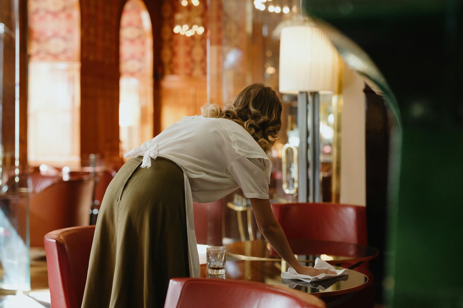 A woman wiping the table | Source: Pexels
